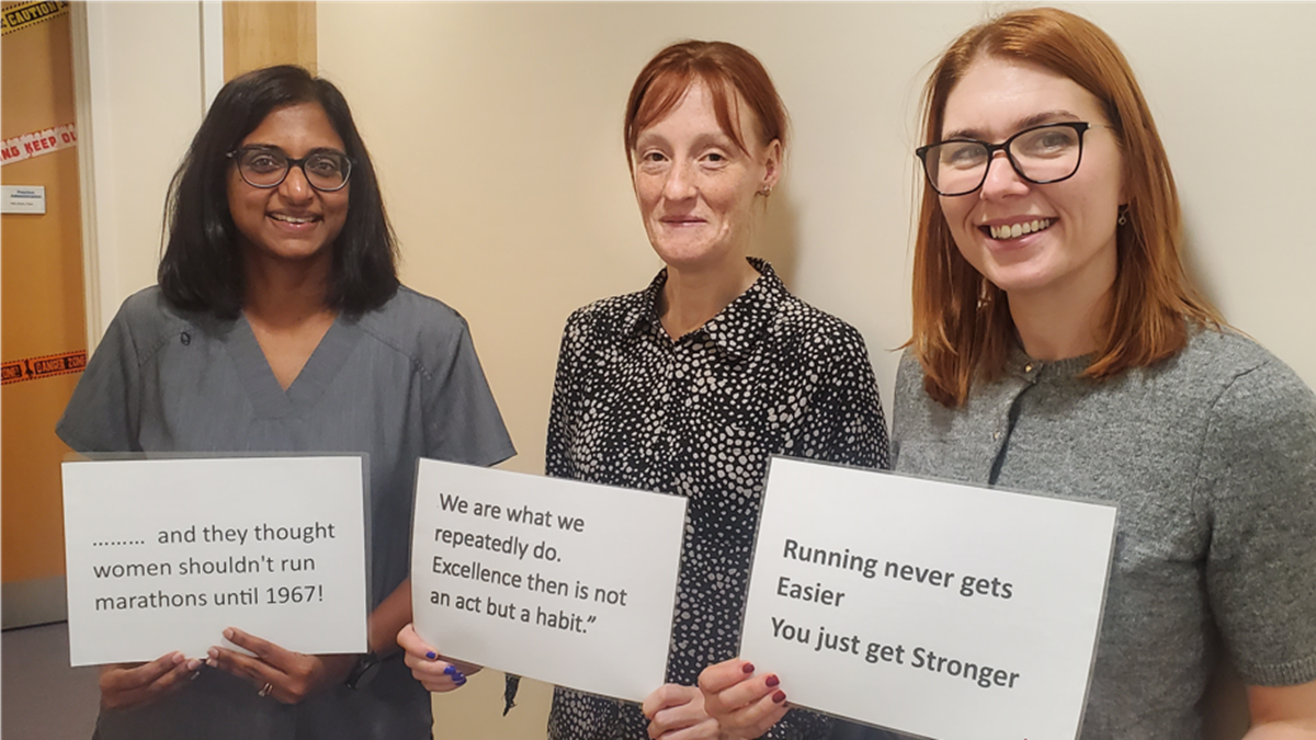 3 Women holding signs